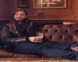 Tom Payne consuming alcohol
